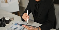 Corporate executive working with digital tablet and stylus for business tasks