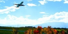 Airplane floating in the autumn blue sky