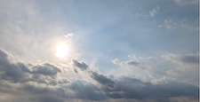 The sun shining through the clouds